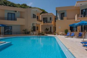 a swimming pool in front of a building at Akasti Hotel in Kalamaki