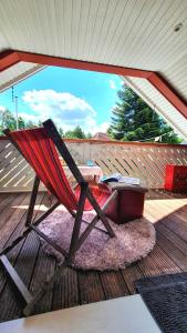 a hammock sitting on a deck with a table at Messe Homestay Hannover Ost in Sehnde
