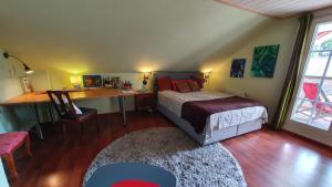 a bedroom with a bed and a desk and a table at Messe Homestay Hannover Ost in Sehnde