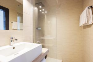 a bathroom with a white sink and a shower at Rotonda in Gordola