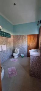 a bathroom with two sinks and two toilets in it at Kartika Villas in Lovina