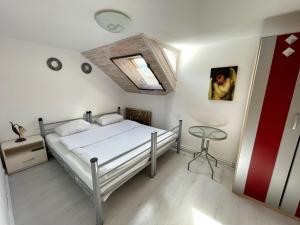 a bedroom with a bed and a window and a table at Dream House Brasov in Braşov +19 photos