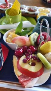 a plate of food with fruit on a table at Messe Homestay Hannover Ost in Sehnde