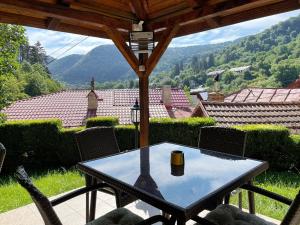 a table on a patio with a view of the mountains at Dream House Brasov in Braşov