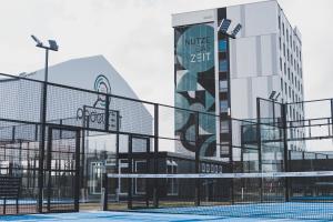a volleyball court in front of a building at Hotel Das Zeit in Lenzing