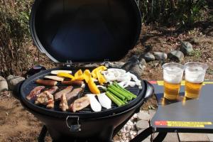 a grill with meat and vegetables and two glasses of beer at Yamaguchi House Villa,Historic Japanese Room with Onsen in Miyanoshita