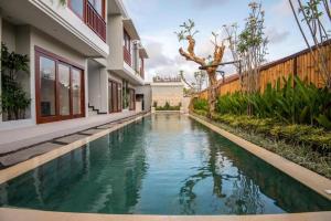 a swimming pool in the middle of a house at Legian Bisma Suite in Seminyak
