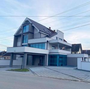 a large white building with a lot of windows at Villa Miss in Bogatić