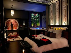 a bedroom with a large bed in a room at Loveroom 50 nuances plus zen Expérience immersive & intimiste in Lagrâce-Dieu