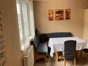 a living room with a table and a couch at Gleinstraße 24 Wohnung in Sankt Margarethen bei Knittelfeld