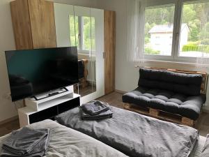 a living room with a couch and a flat screen tv at Gleinstraße 24 Wohnung in Sankt Margarethen bei Knittelfeld