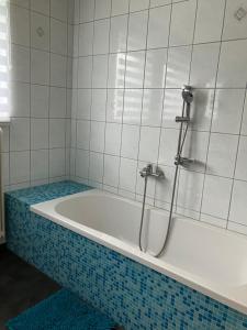 a bath tub with a shower in a bathroom at Gleinstraße 24 Wohnung in Sankt Margarethen bei Knittelfeld