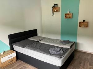 a bedroom with a bed with a black headboard at Gleinstraße 24 Wohnung in Sankt Margarethen bei Knittelfeld