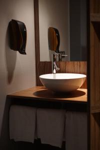 a bathroom with a white sink and a mirror at Hôtel Du Parc - Pirates in Chasseneuil-du-Poitou