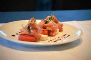 a white plate of food on a table at Hotel Das Zeit in Lenzing