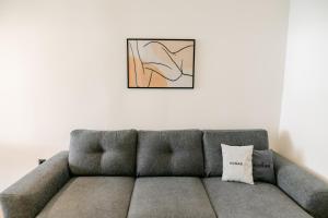 a couch in a living room with a picture on the wall at Zen Sea in Alexandroupoli