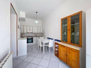 a kitchen and dining room with a table and chairs at Appartamento La Costarella in Marciana