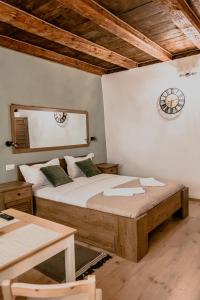 a bedroom with a bed and a clock on the wall at Central garden apartments in Braşov