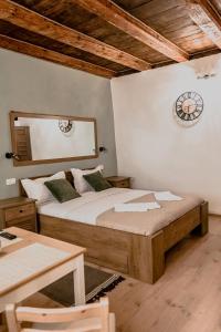 a bedroom with a large bed and a table at Central garden apartments in Braşov