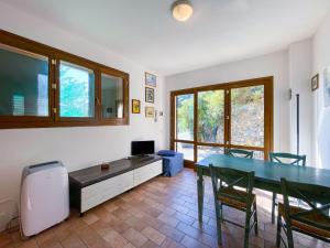 a living room with a dining room table and chairs at Monolocale Vittorio in Portoferraio