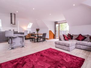 a living room with a couch and a table at The Barn at Mulberry Lodge in Maidstone