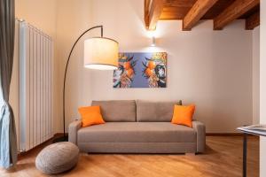 a living room with a couch and a lamp at Open Sicily Homes "Residence ai Quattro Canti" - Self check in - Deposito Bagagli in Palermo