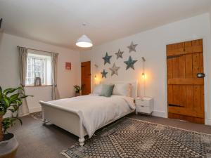 a bedroom with a bed with stars on the wall at Old Rectory Cottage in Lincoln