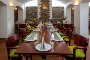 a dining room with a long wooden table and chairs at Gästehaus Dresden - Alte Schule Gohlis in Dresden