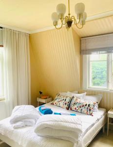 ein Bett mit weißer Bettwäsche und Kissen in einem Schlafzimmer in der Unterkunft Hemma hos Jeanette & Micke på Peresgården in Vikarbyn