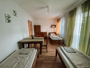 a room with two beds and a table and a couch at Bielik in Dęblin