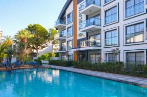 a swimming pool in front of a building at Juglans Suites in Fethiye