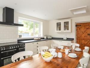 a kitchen with a wooden table with bananas on it at Ty Coch in Caernarfon