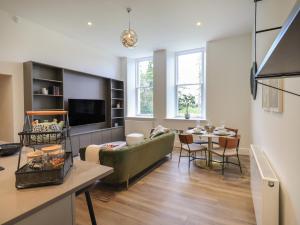 a living room with a couch and a table at The Alfred Suite Stone Cross Mansion in Ulverston