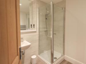 a shower with a glass door in a bathroom at The Alfred Suite Stone Cross Mansion in Ulverston +51 photos
