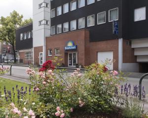 Ein Gebäude mit einem Blumenstrauß davor. in der Unterkunft Days Inn Dortmund West in Dortmund
