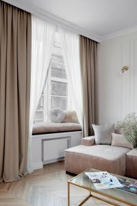 a living room with a couch and a window at Elite Apartments Piwna Prestige in Gdańsk