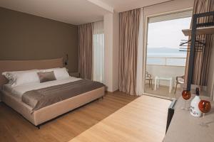 Schlafzimmer mit einem Bett und Meerblick in der Unterkunft Grand Mirage in Vlorë