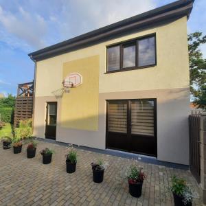 a house with a basketball hoop on the side of it at Nicas guest house in Liepāja