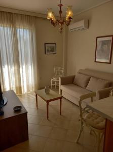 a living room with a couch and a table at Jenny's luxury flat near the center & Beach in Kalamata