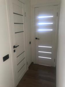 a room with a door and a hallway with a floor at Apartment Avenue View in Kamianets-Podilskyi
