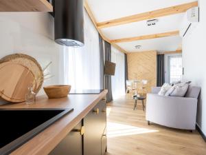 a kitchen and living room with a table and a couch at Apartamenty Klemensówka in Zakopane