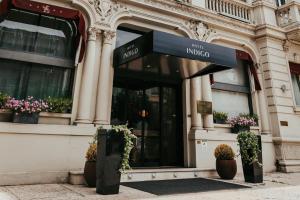 a store front of a building with potted plants at Hotel Indigo Verona - Grand Hotel Des Arts by IHG in Verona