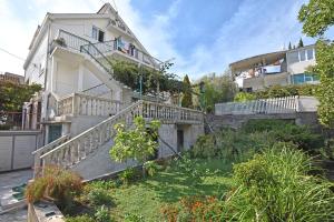 a house with stairs and a garden in front of it at Apartments Kujacic in Herceg-Novi