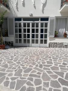a patio with a stone floor in front of a building at Villa Porto delle Genti in Lipari