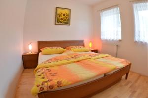 a bedroom with a bed and two lamps on tables at Apartments Rožič in Kranjska Gora