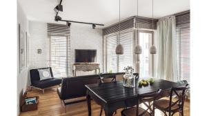 a living room with a table and chairs and a television at BCN Waterlane in Gdańsk