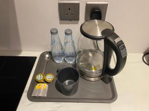 a tray with two bottles of water on a counter at 3 - Bedroom Apartment in Riyadh