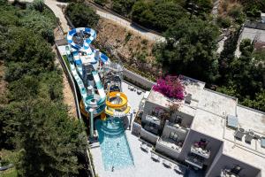 an aerial view of a water park with a roller coaster at Porto Platanias Village Resort in Plataniás