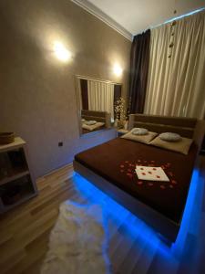 Un dormitorio con una cama con luces azules. en Wellness Stodolni Ostrava, en Ostrava