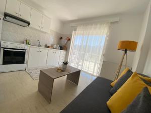 a living room with a couch and a table at Noufaro rooftop-sea view apartment in Zipárion